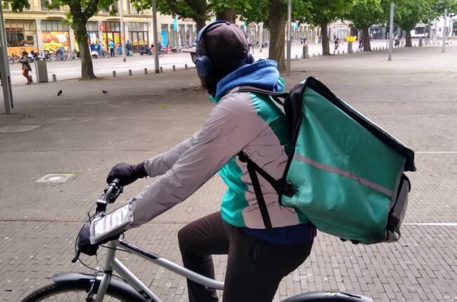 An undocumented migrant delivers Deliveroo during lockdown