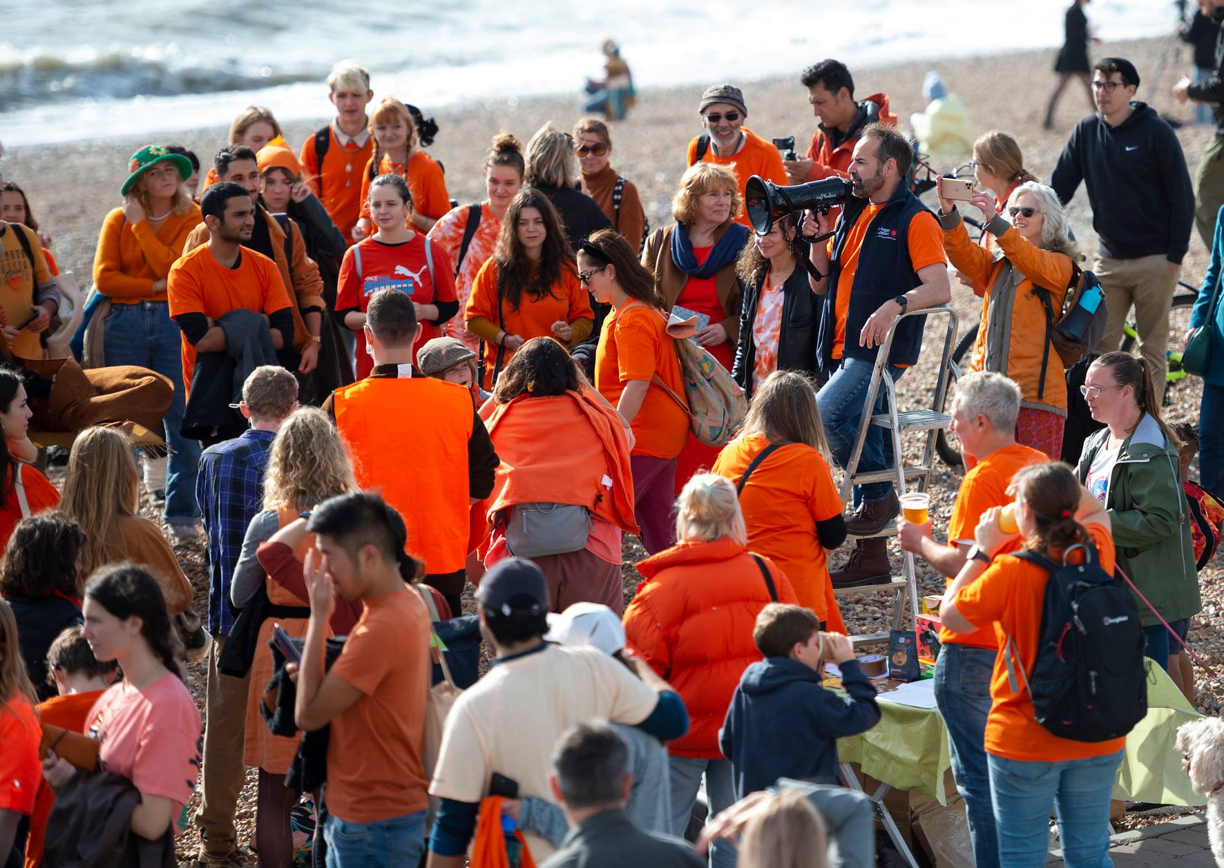 Sanctuary on Sea volunteers all wearing orange to show their solidarity